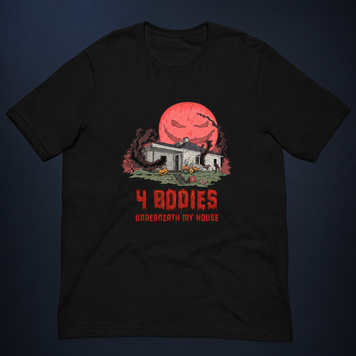 4 Bodies Underneath My House black tee, front flatlay with red moon and haunted house graphic, shown on a dark charcoal studio background.